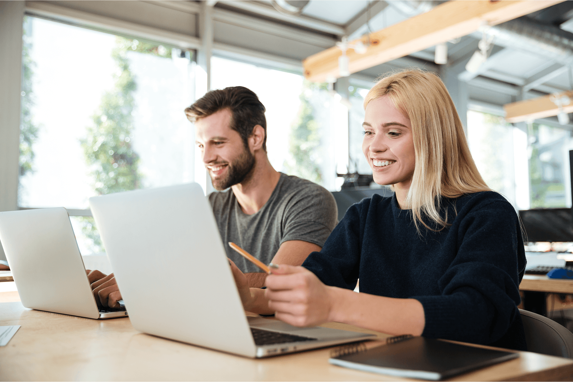 concentrated-young-colleagues-sitting-office-coworking